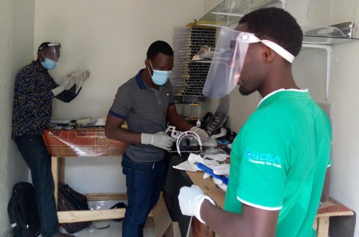 Global auto systems team members making face shields in Uganda