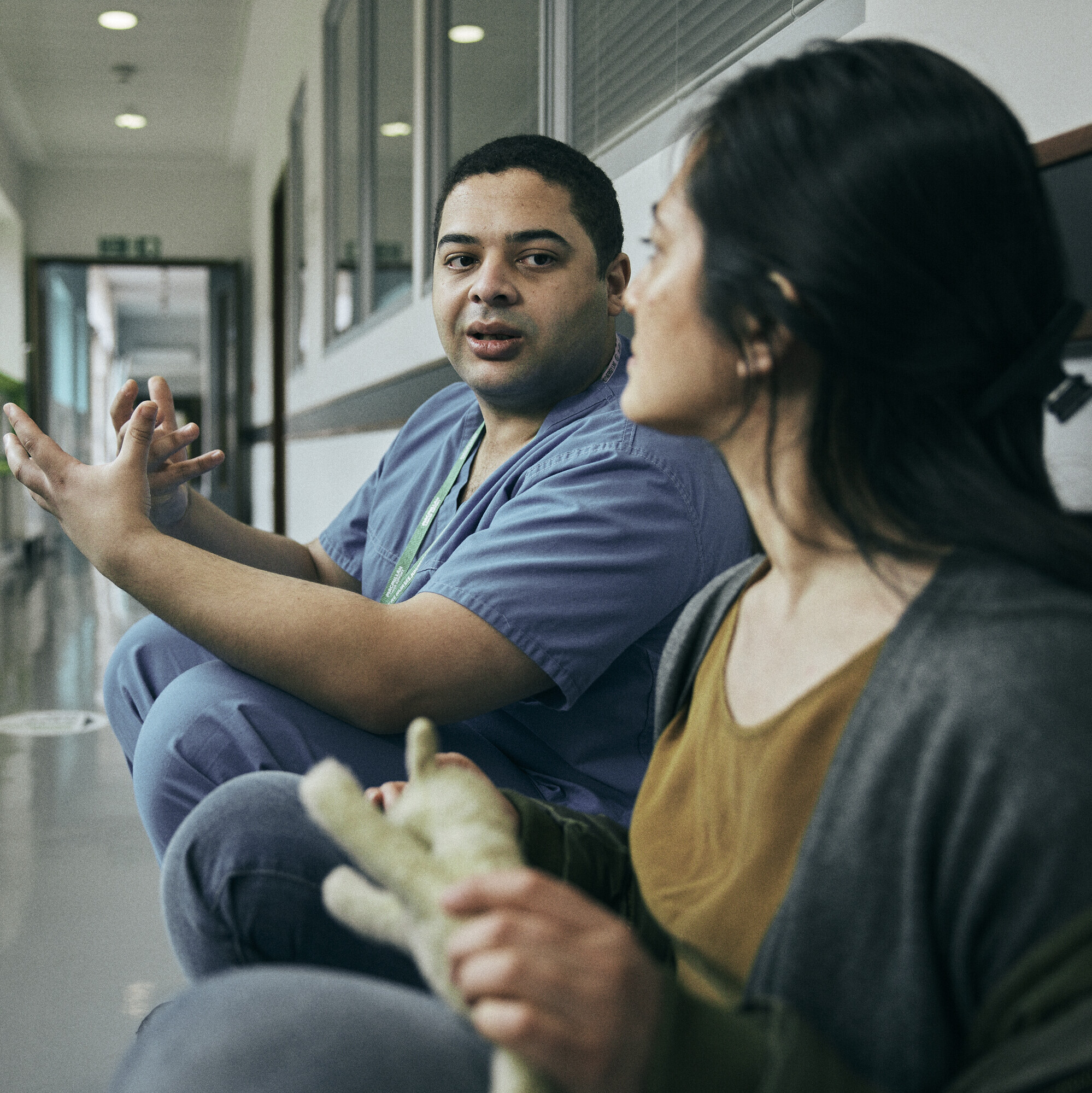 A Macmillan nurse in conversation with a patient in a hospital corridor
